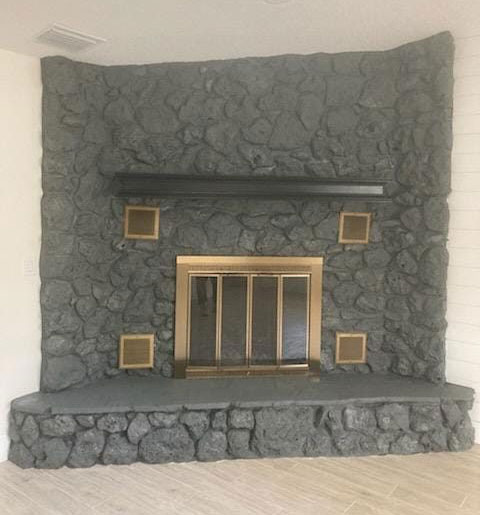 Stone fireplace painted charcoal grey after interior painting